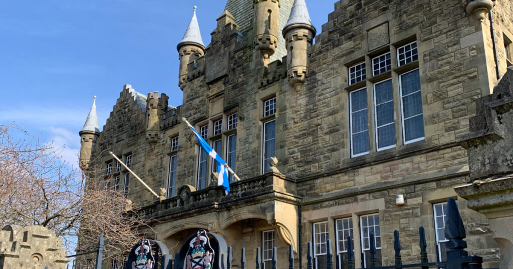 Photograph of the front of Victoria Halls, Helensburgh, including the metal gates and Helensburgh Coat of Arms. © A Foy.