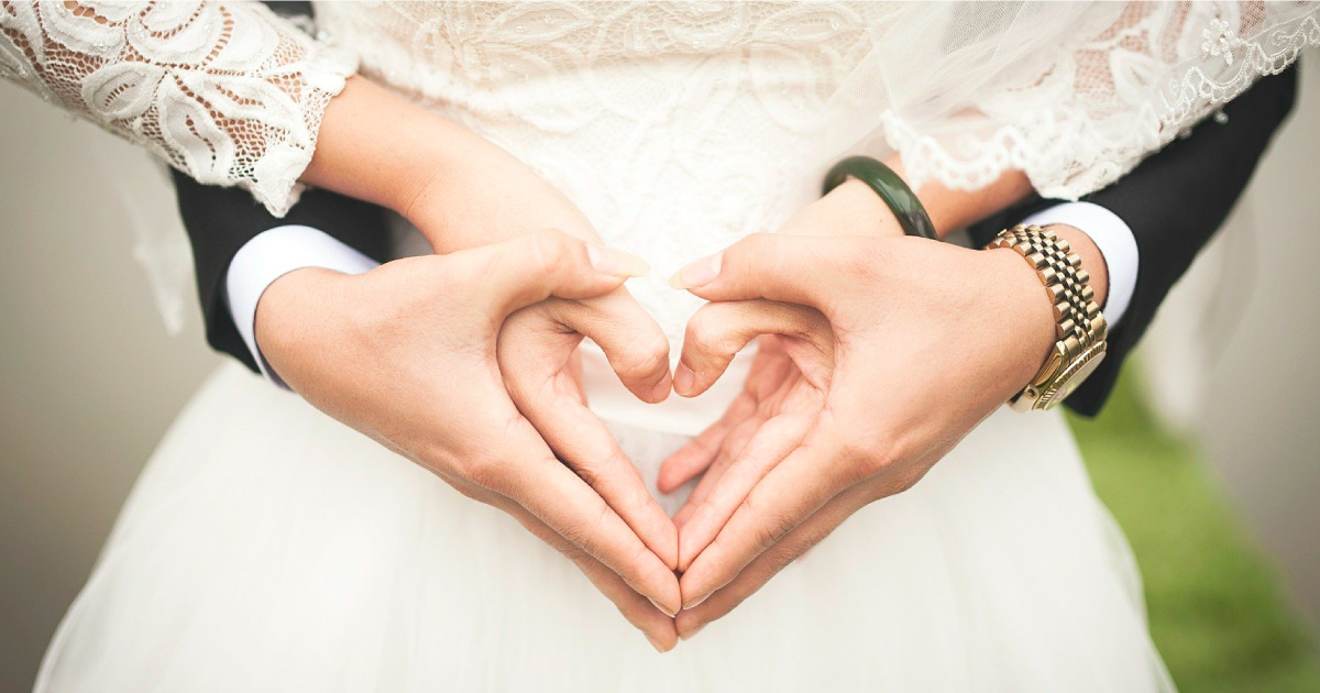 Photograph of two people holding hands in a heart shape. Image Source: https://pixabay.com/photos/heart-wedding-marriage-hands-529607/