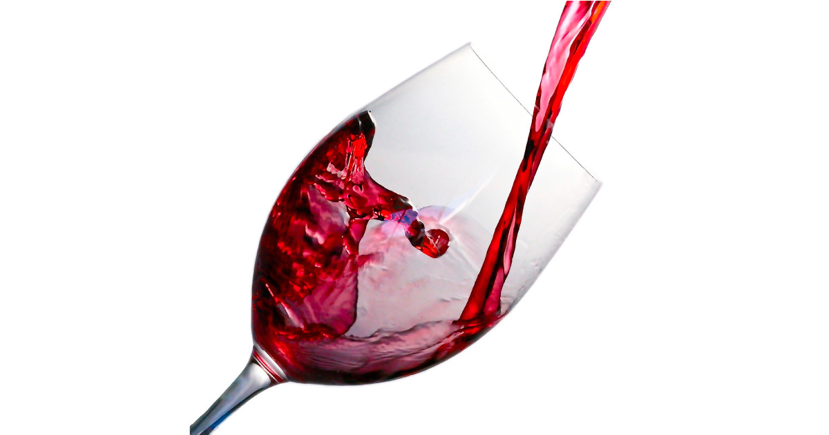 Glass of red wine being poured. Image source: https://pixabay.com/photos/wine-splash-glass-red-alcohol-1543170/